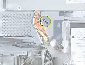 Using a needlenose pliers, squeeze the tabs (located beside the power supply