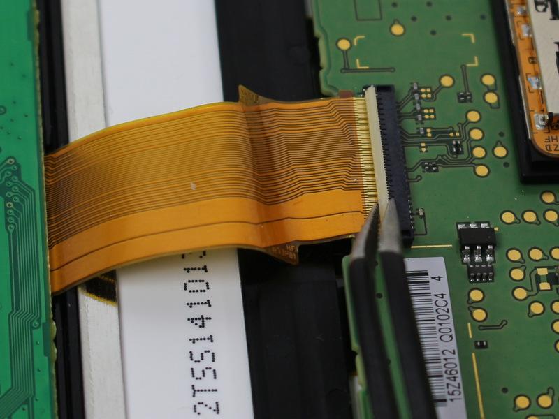 Three of the ribbon connectors have plastic clamping flaps that cover the ribbon to prevent slippage. Use the tweezers to flip them up before ribbon removal.