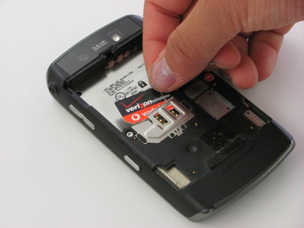 Step 4 Once you have located the SIM card, carefully remove it by sliding it upwards out of the metal tray.