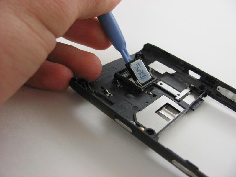 Lightly force the back speaker off of the panel by lifting the