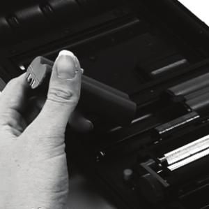 Open the printer's cover (Figure 1). 2. If applicable, remove the batteries by pressing the retainer clip outward with your thumb (Figure 2).