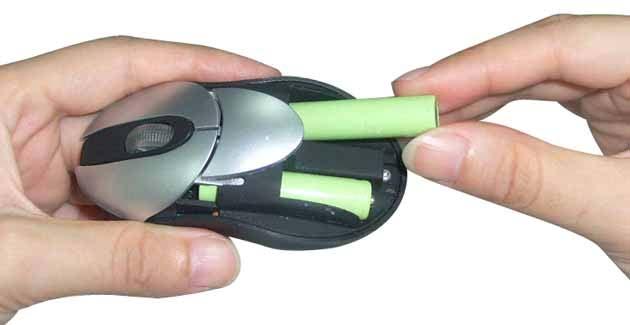 Remove the Battery Compartment Cover of your Mouse by pressing the silver release button in the