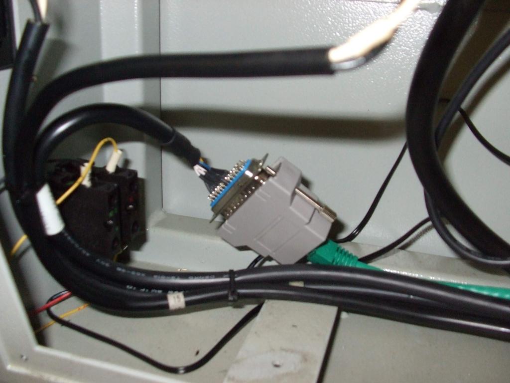 Locate the serial port connector of the CNC. Attach one end of the CAT5 cable to the serial port connector of the LANCNC controller.