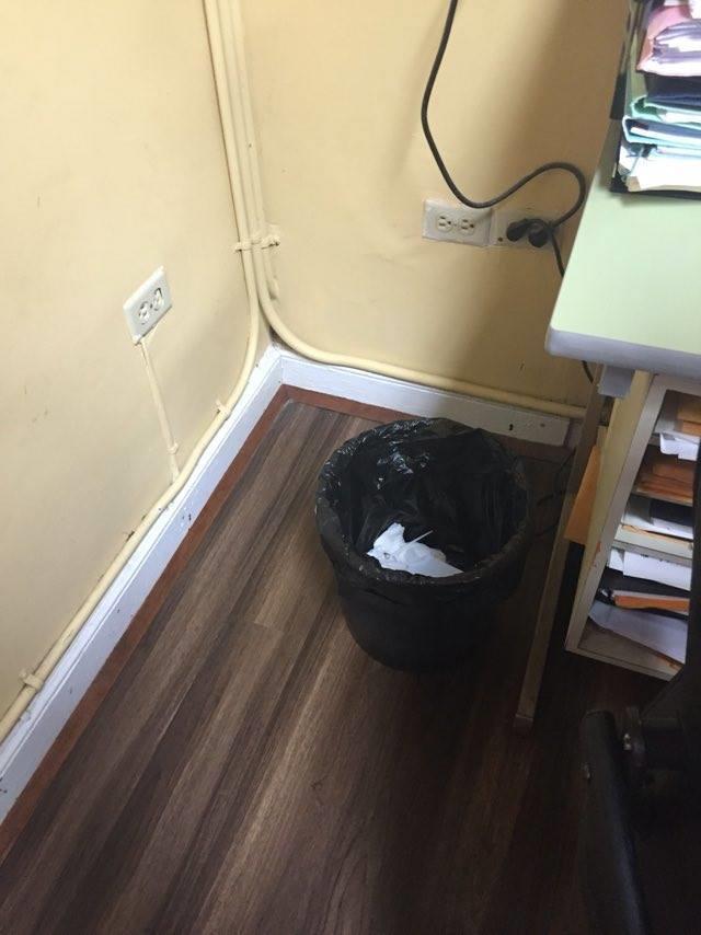 Rubbish Bin removed from under the desk and placed to the side, while still within