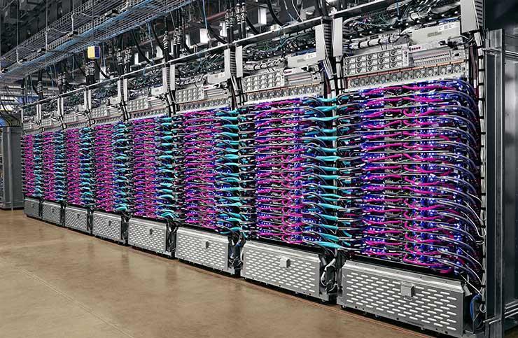GOOGLE SHIFTS TO LIQUID COOLING FOR AI DATA CRUNCHING An eight-rack pod of Google's