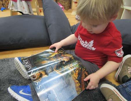 Nidya brought in some National Geographic magazines for the toddlers to explore.