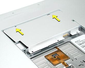 8. To reinstall the memory door, hold it at a low angle to the battery bay and slide it in under the back edge, then lay it flat.