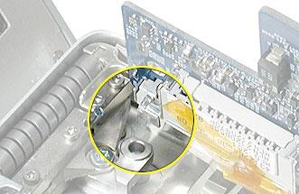 6. Carefully coax the port end of the board out of the port openings. Note: The DVI connector may catch on the part of the frame shown here. Carefully maneuver it until it releases.