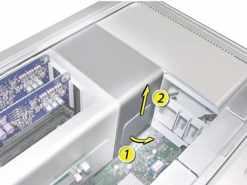 Place the fingers of one hand under the lip of the heatsink cover nearest the logic board.