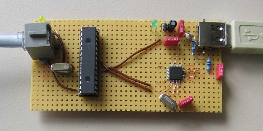 Figure 3.2: Primary prototype of the own sensor board. The board consists of the signal controller dspic from Microchip and an USB- RS232 converter.