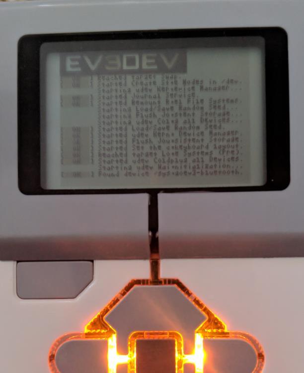 This is immediately followed by the ev3dev boot screen and the LEDs changing to orange.