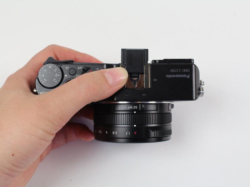 Pull the black plastic piece off of the viewfinder.