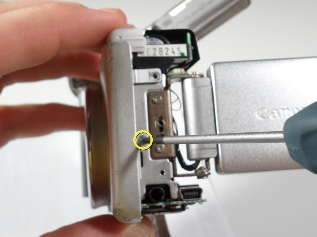 Gently remove the side panel of the camera by pulling it away form the camera.