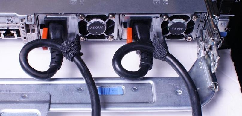 After you have installed the tray and cables, route the power cables through the strain reliefs located on the power supply handles as shown in Figure 2.