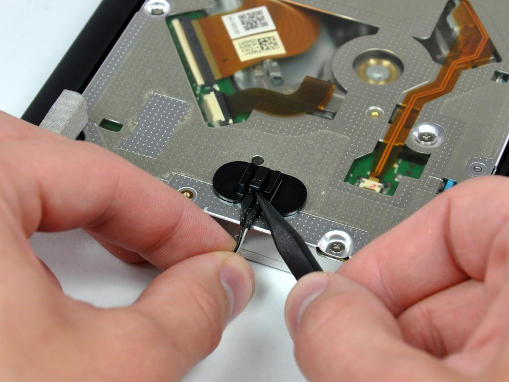 Step 18 To remove the optical drive thermal sensor, use the tip of a spudger to lift the center finger of the thermal sensor bracket while applying