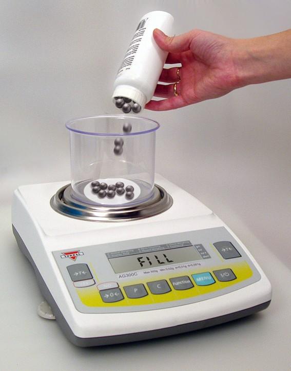 6. Once the weight of the sample stabilizes and the stability indicator appears on the display, press T to confirm and accept the sample weight. 7.