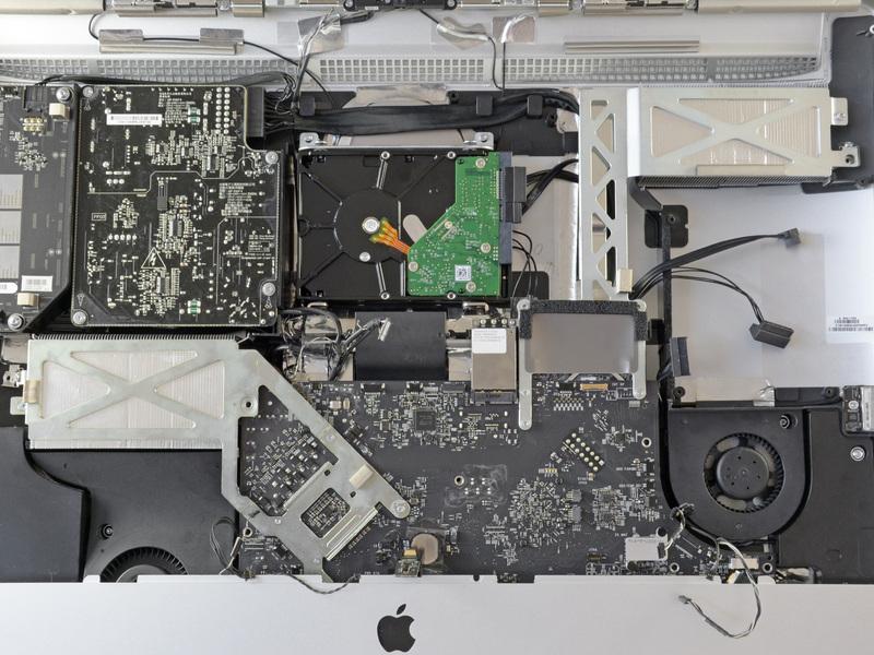 Set the logic board back into place, being careful not to catch, cover, or pinch any cables.