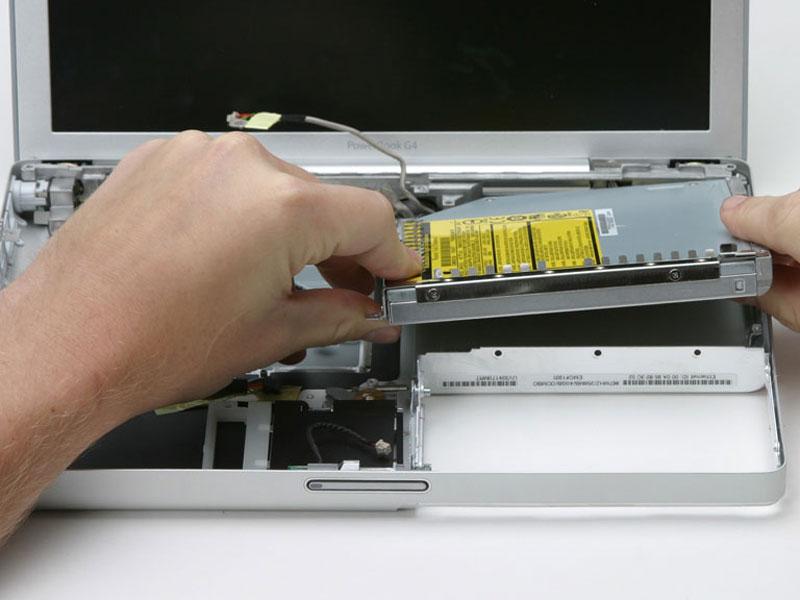 Step 51 Lift the optical drive up by its front left corner and pull it out of the