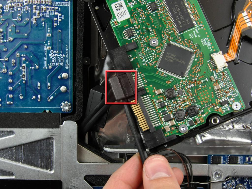 Disconnect the SATA data cable by pulling its connector away