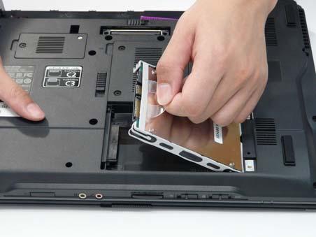 Use the mylar tab to slide and lift up the hard disk