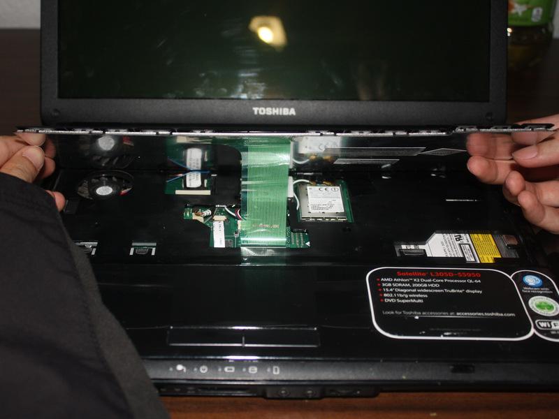 Under the keyboard there is a ribbon cable connecting the