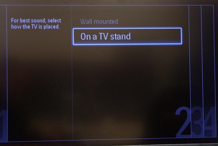 The next step is to select Wall mounted or On a TV stand. This option changes some settings for the audio and image of the TV. Now you can select the visual and hearing impaired options.