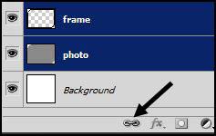 Shift click on the photo layer to make both layers active at the same time. Click on the Link Layers icon at the bottom of the Layers panel.