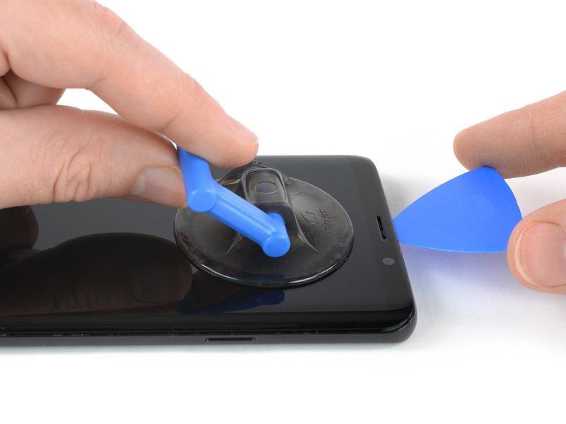 Step 17 Once the screen is warm to the touch, apply a suction cup to the