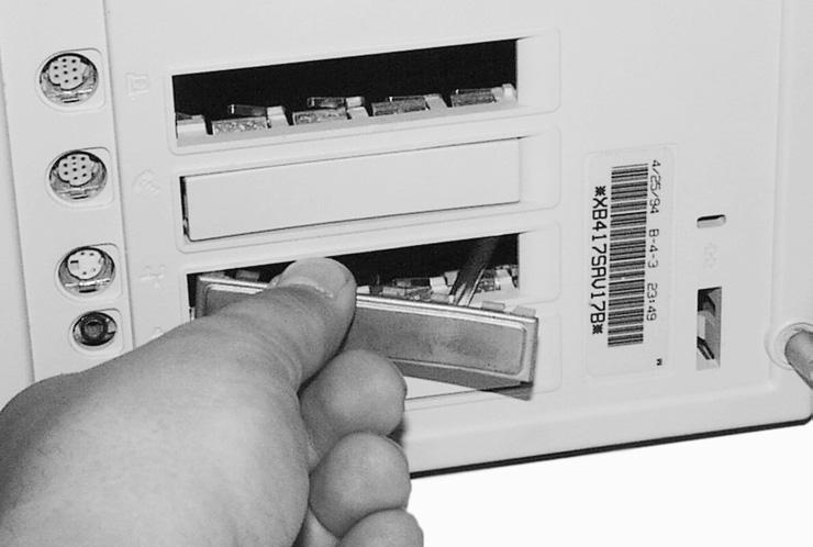 Remove the access port cover (if installed) from the middle NuBus port located at the back of the computer (Figure 40).