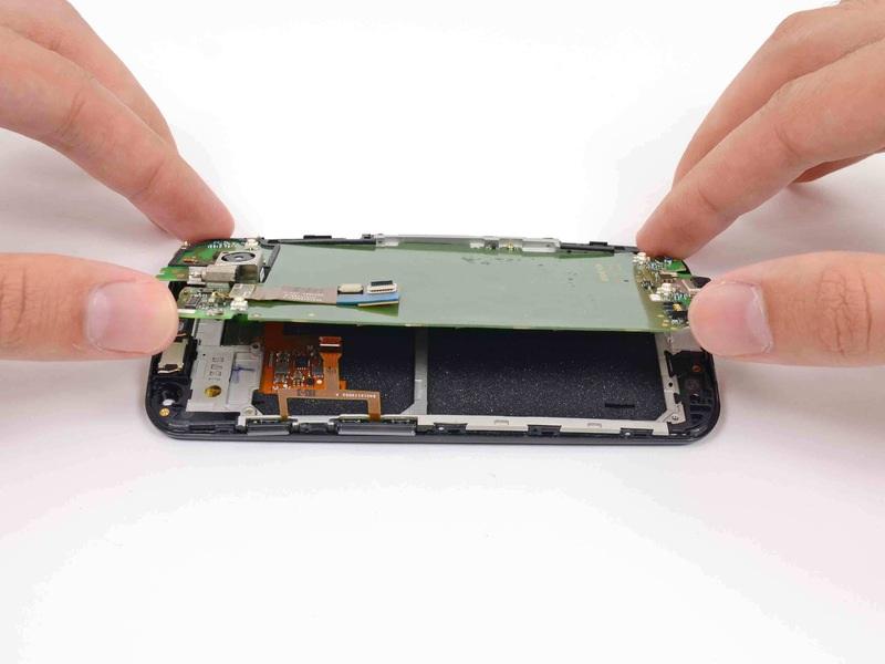 Step 26 Gently lift the motherboard out of the phone, rotating it from the SIM slot edge of the phone.
