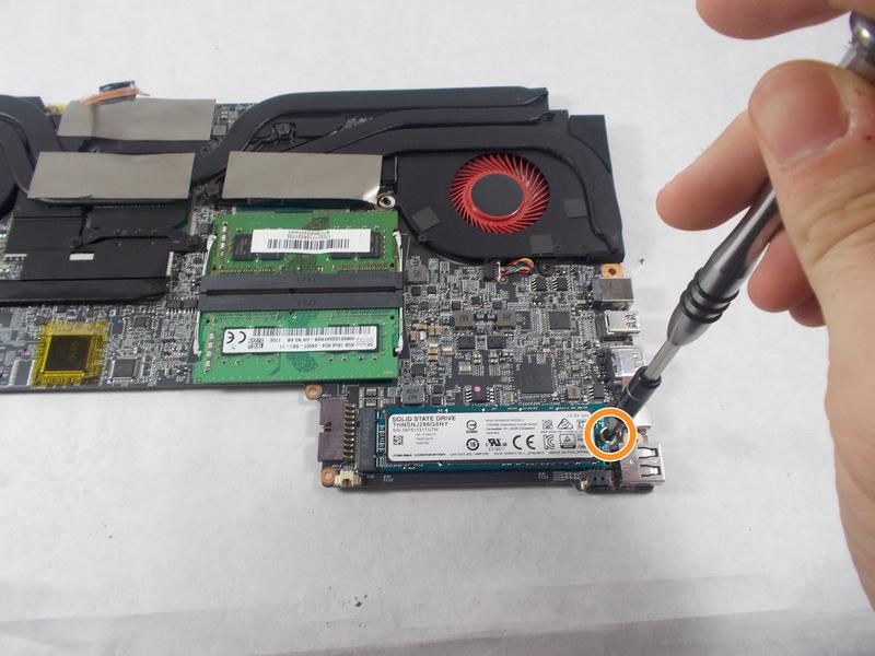 Using tweezers, disconnect the red wire circled in the picture; where the hard drive would be.