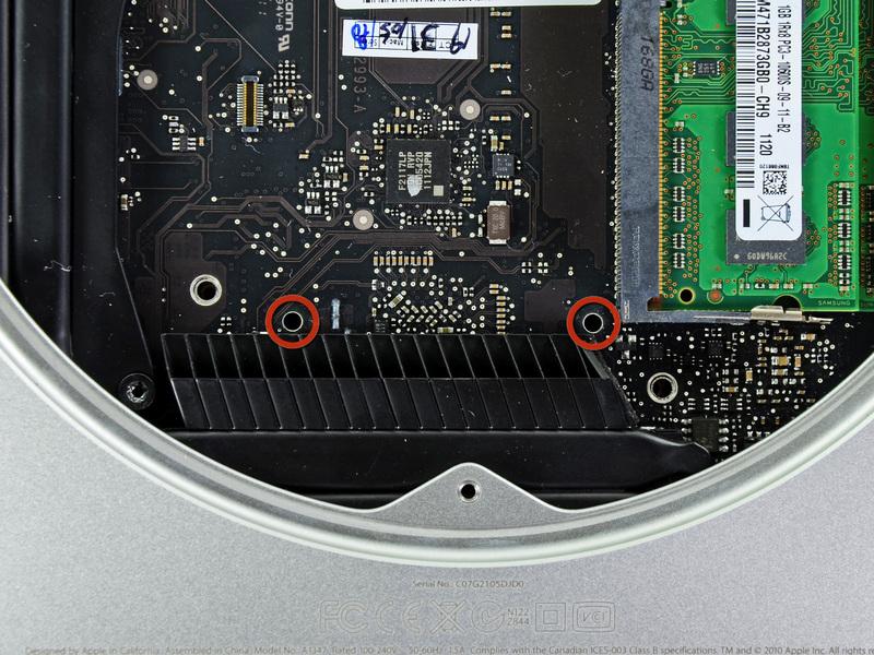 Step 15 To remove the logic board, the two cylindrical rods of the Mac Mini Logic Board Removal Tool must be inserted