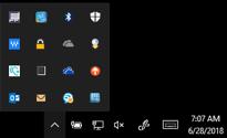 Some versions display icons in a row while others (e.g. Windows 0) compile icons into a pop up that requires a click on the up arrow to display hidden icons.