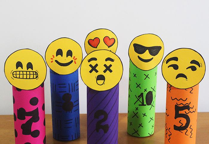 Emoji Bowling 6 Empty and washed water bottles Yellow construction paper Sharpies Scissors Sand Other color construction paper Double sided tape Ball Draw six emoji faces and cut them out Fill each
