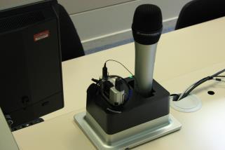 The lectern mic has a switch which turns red when the mic is live.