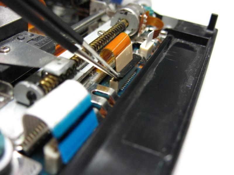 Note: The ribbon cable in the center must be unlocked by lifting up the