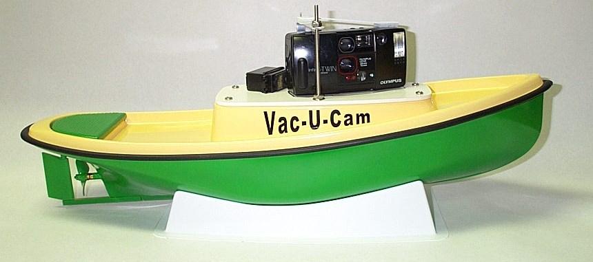 With a 2-channel radio, you can "Y" connect the shutter servo to the rudder servo to take photos while sitting still in the water. It has the same hull and running gear as the Vac-U-Tug Jr.