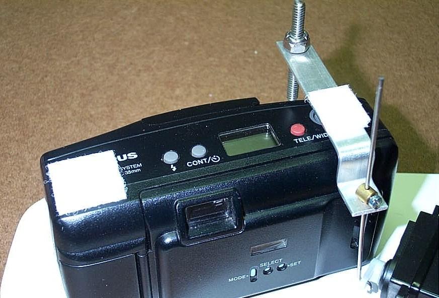 Trim one end if it overhangs the camera or the Shutter Arm.