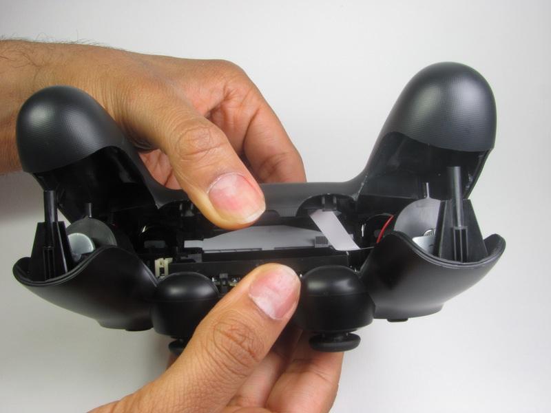 Split the plastic covers of the controller apart, taking note that they will