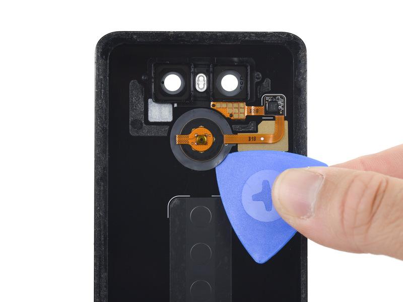 Remove the bracket. Step 12 Slide an opening pick between the rear button membrane and the rear case. Slide the pick around the edge of the membrane to separate it from the rear case.