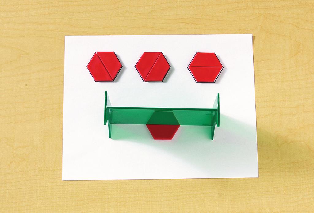 pattern blocks (1 hexagon and 7 trapezoids per group) GeoReflector mirror (1 per group) paper (1 sheet per group) pencils (1 per group) 1.