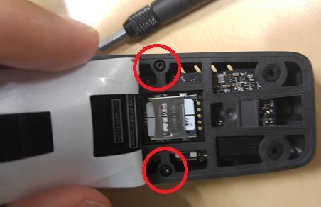 - Remove both screws under the sticker and then quickly put the sticker back in