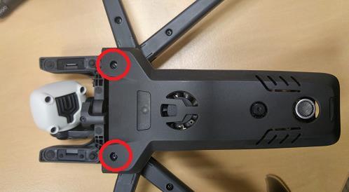 - Remove both screws from the bottom of the drone at the arms junction.