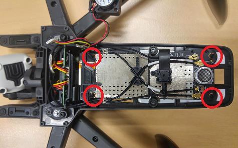 - Remove the four rubbers gently: Parrot recommends you hold the motherboard during the