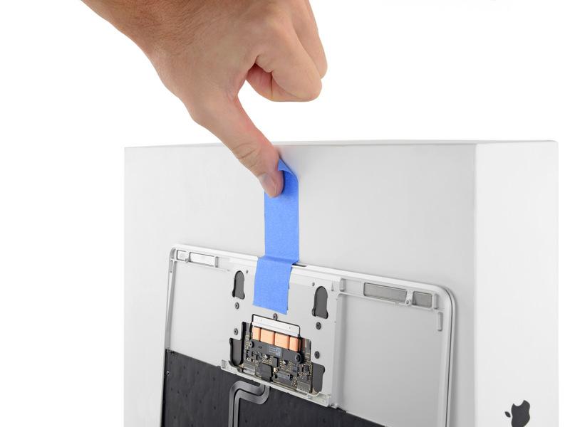 hold it. Add a piece of tape near the track pad to secure the upper case and prevent accidental movement.