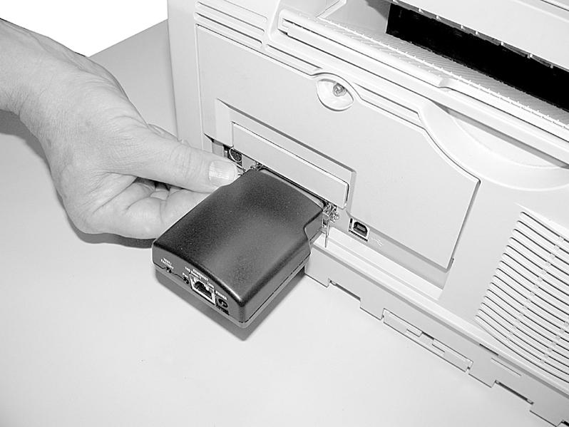 Secure the print server with the wire clips on the printer