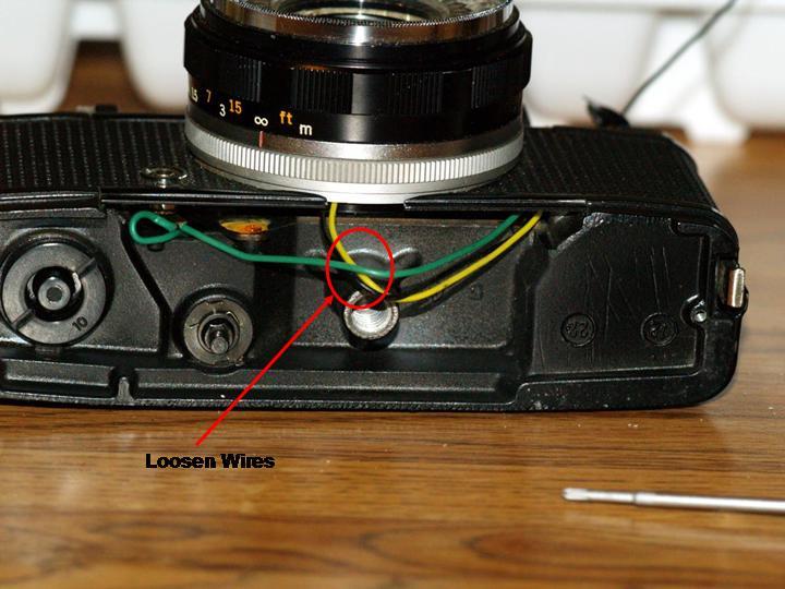 10. Remove the screws that hold the photocell in