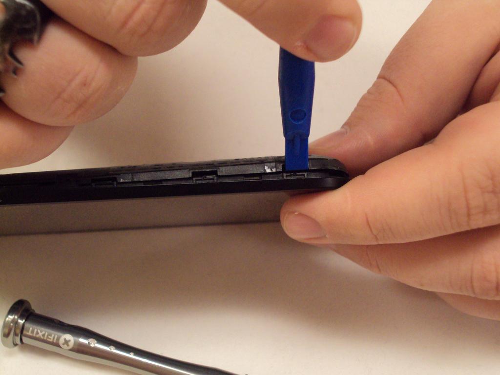 Step 4 With the screen facing you and the front facing camera to your right, insert the plastic opening tool