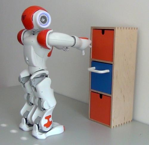 The robot first plans a motion to grasp the handle and then a