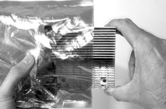 Grasp the Duet processor card with its heat sink face down and the fan on the left (Figure 42).